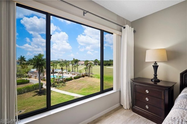 7430 Lake Breeze Dr Unit 402, Fort Myers, FL 33907 - bedroom featuring baseboards, multiple windows, and light wood finished floors