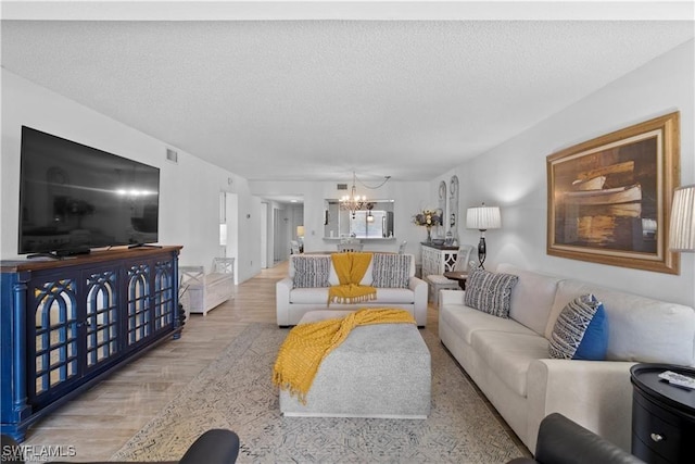 7430 Lake Breeze Dr Unit 402, Fort Myers, FL 33907 - living room with a chandelier, wood finished floors, and a textured ceiling
