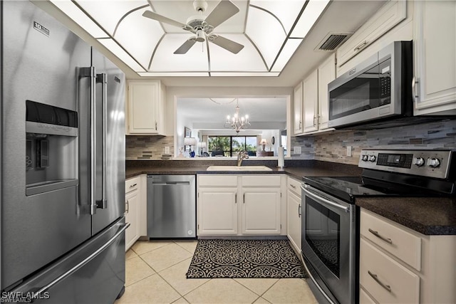 7430 Lake Breeze Dr Unit 402, Fort Myers, FL 33907 - kitchen with appliances with stainless steel finishes, dark countertops, ceiling fan, and backsplash