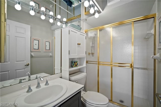 bathroom with vanity, toilet, and an enclosed shower