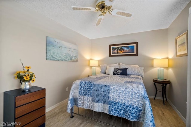 7430 Lake Breeze Dr Unit 402, Fort Myers, FL 33907 - bedroom featuring wood finished floors, a textured ceiling, baseboards, and a ceiling fan