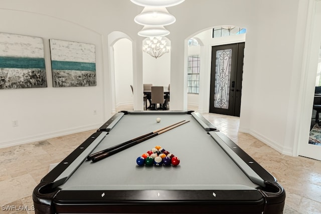 playroom featuring french doors, an inviting chandelier, and billiards