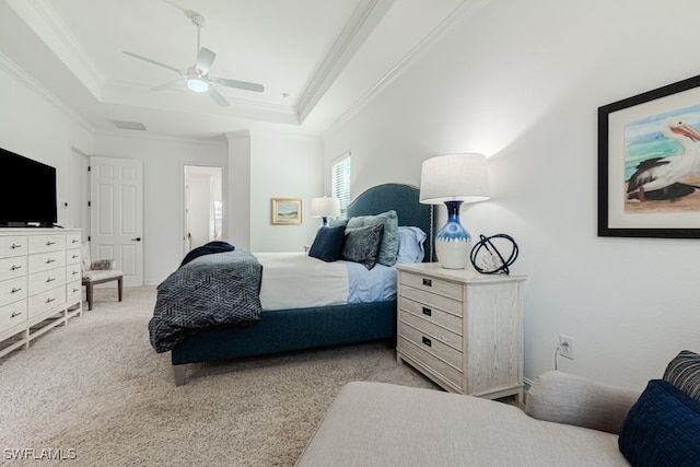 bedroom with a tray ceiling, ceiling fan, light colored carpet, and ornamental molding