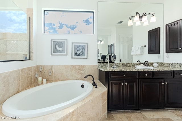 bathroom with vanity, ornamental molding, and tiled tub