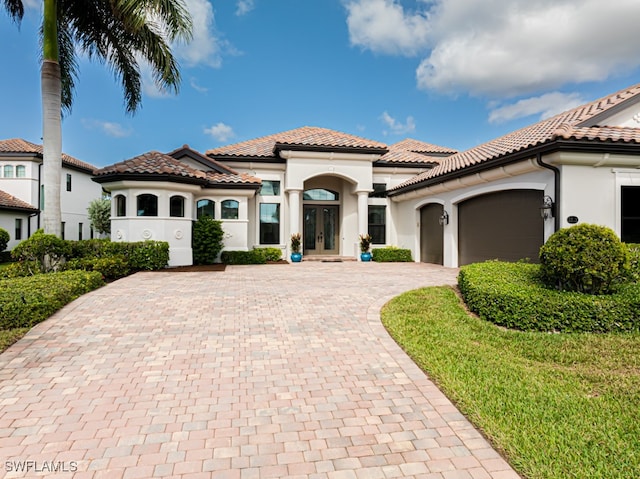 mediterranean / spanish-style home featuring a garage