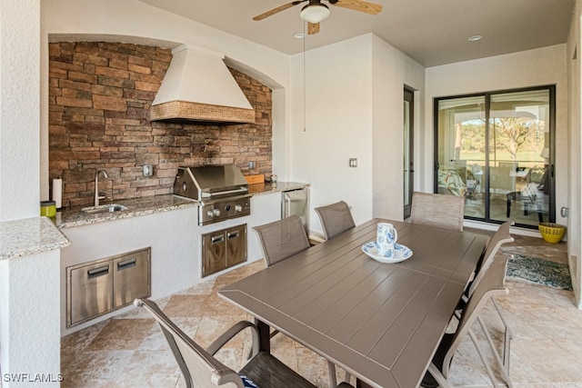 dining space featuring ceiling fan and sink