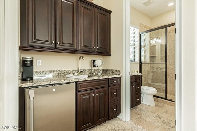 3273 Runaway Ln, Naples, FL 34114 - indoor wet bar with stainless steel fridge and stone tile floors