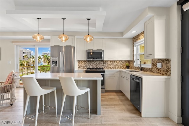 kitchen featuring plenty of natural light, white cabinets, stainless steel appliances, and sink