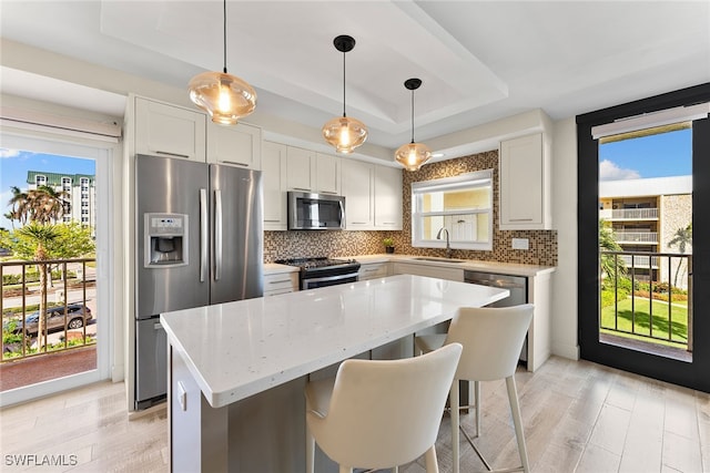 kitchen with sink, a healthy amount of sunlight, and appliances with stainless steel finishes