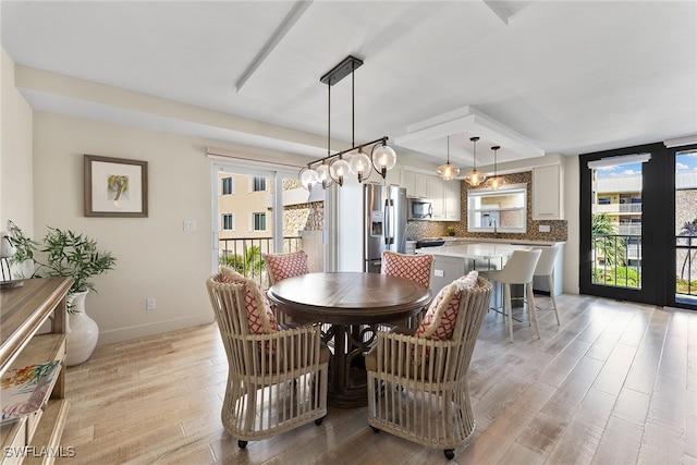 dining room featuring a healthy amount of sunlight and light wood-type flooring