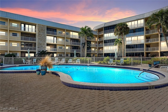 view of pool at dusk