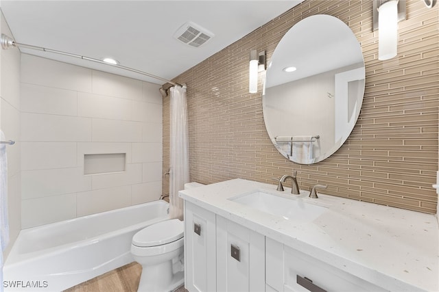 full bathroom featuring decorative backsplash, vanity, shower / tub combo with curtain, tile walls, and toilet