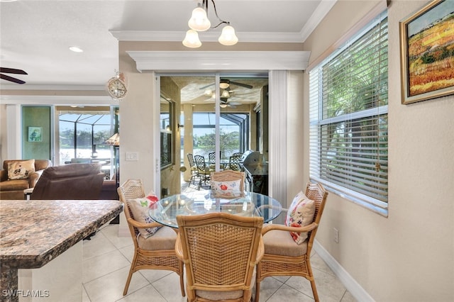 dining room featuring a wealth of natural light, light tile patterned floors, and ornamental molding