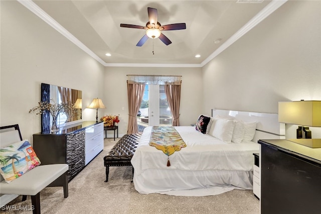 carpeted bedroom with access to exterior, ceiling fan, french doors, crown molding, and a tray ceiling