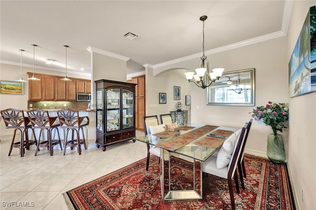 tiled dining space featuring ornamental molding and a notable chandelier