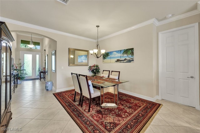 dining room with light tile patterned floors, ornamental molding, and a notable chandelier