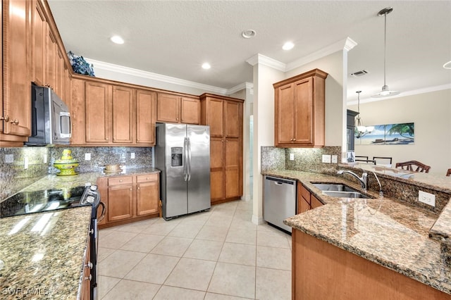 kitchen featuring decorative backsplash, stainless steel appliances, hanging light fixtures, and sink