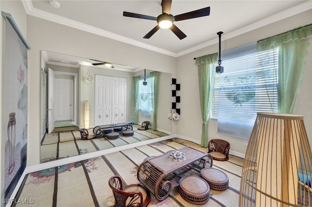 living room featuring ceiling fan, carpet floors, and crown molding