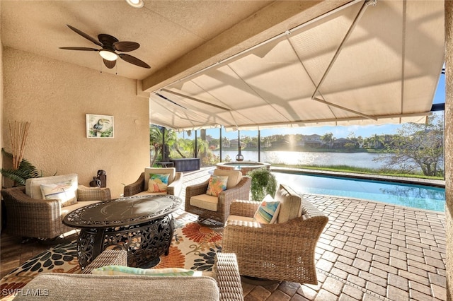 view of patio with ceiling fan, a water view, and an outdoor hangout area