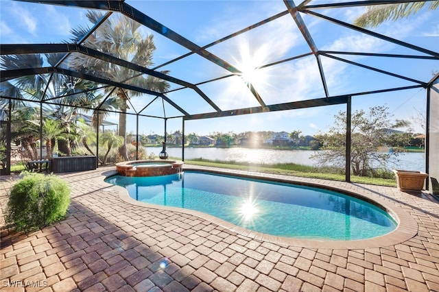 view of pool featuring glass enclosure, a patio area, a water view, and an in ground hot tub