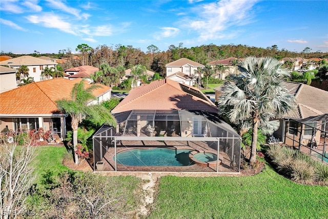 view of swimming pool featuring an in ground hot tub, a yard, and a patio