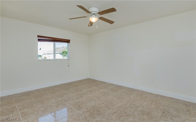 tiled empty room featuring ceiling fan