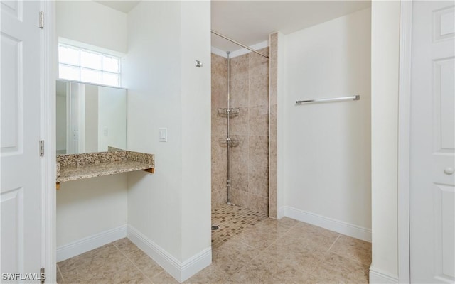 bathroom featuring tiled shower and tile patterned floors