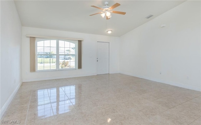 tiled empty room featuring ceiling fan