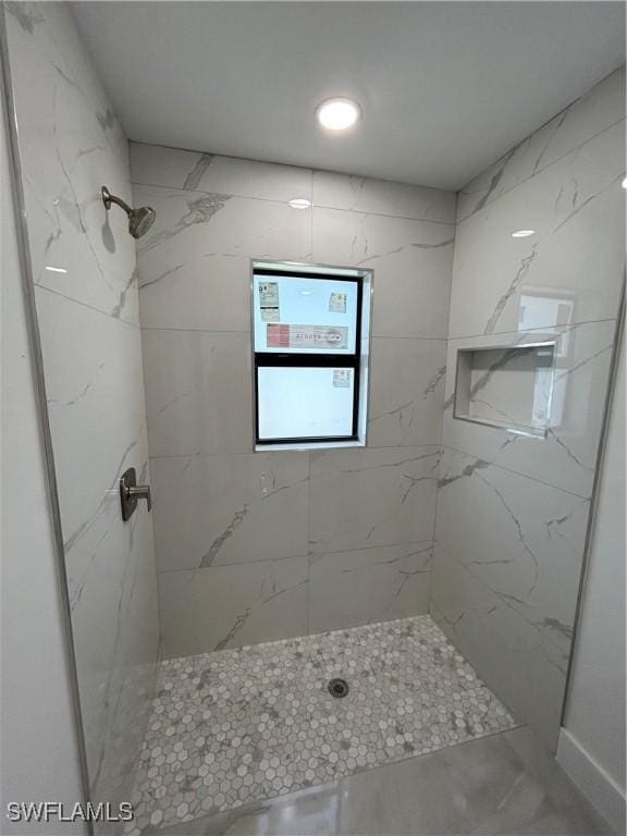 bathroom featuring a tile shower