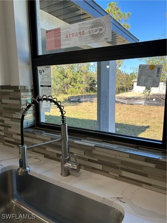 room details featuring backsplash and sink