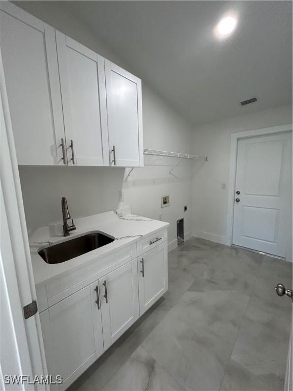 laundry area with electric dryer hookup, cabinets, washer hookup, and sink