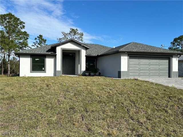 view of front of house with a front yard and a garage