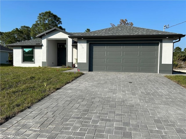 single story home featuring a front lawn and a garage