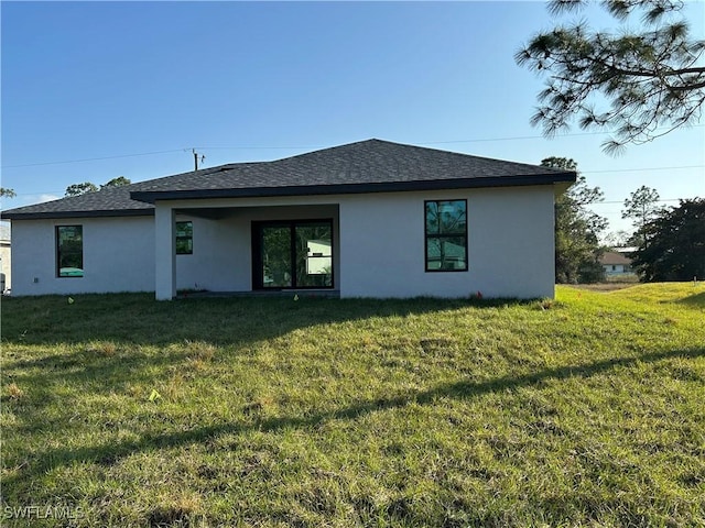 back of property featuring a lawn