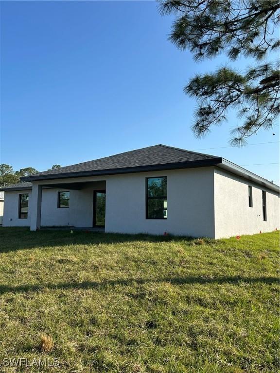 rear view of house with a lawn