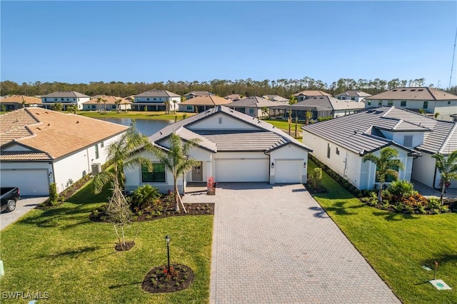 21079 Hallandale Dr, Estero, FL 33928 - view of front of home featuring a residential view, an attached garage, decorative driveway, and a front yard