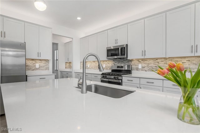 21079 Hallandale Dr, Estero, FL 33928 - kitchen with appliances with stainless steel finishes, tasteful backsplash, light countertops, and recessed lighting