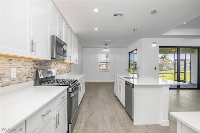 21079 Hallandale Dr, Estero, FL 33928 - kitchen with appliances with stainless steel finishes, light wood-style flooring, backsplash, light countertops, and recessed lighting