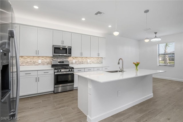 21079 Hallandale Dr, Estero, FL 33928 - kitchen with stainless steel appliances, light wood-style floors, decorative backsplash, light countertops, and recessed lighting
