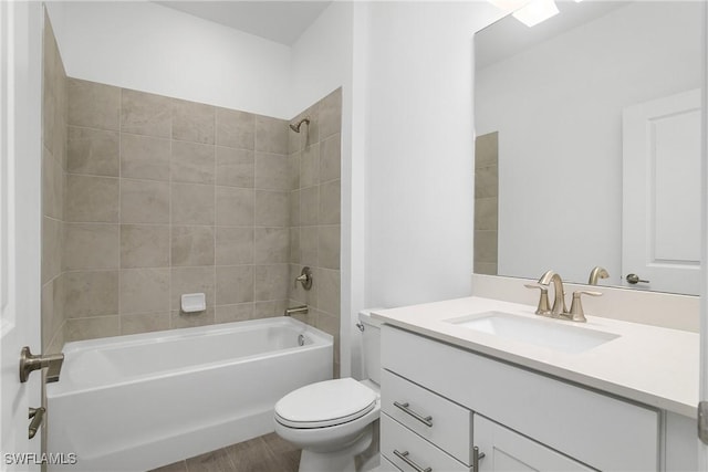 full bathroom with vanity, toilet, and tiled shower / bath