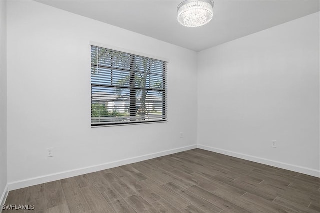 21079 Hallandale Dr, Estero, FL 33928 - empty room with a chandelier and wood finished floors