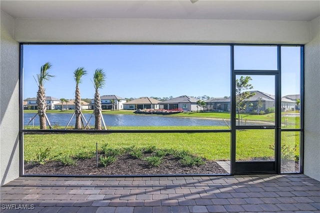 unfurnished sunroom with a water view