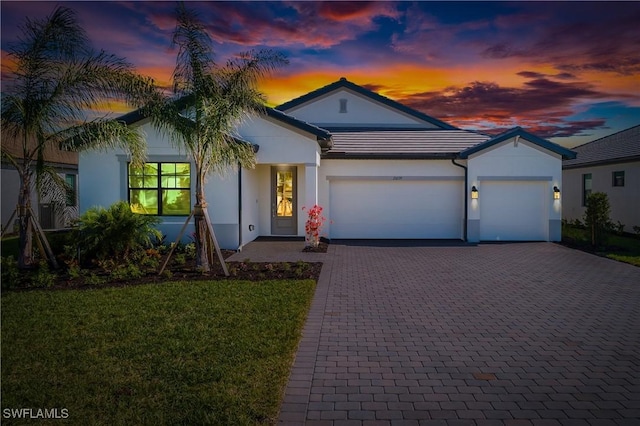 view of front facade with a yard and a garage