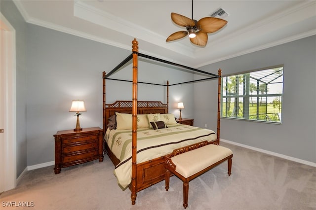 bedroom featuring light carpet, ornamental molding, a raised ceiling, and ceiling fan