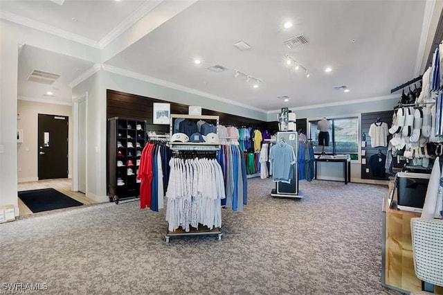 workout area with ornamental molding, rail lighting, and carpet