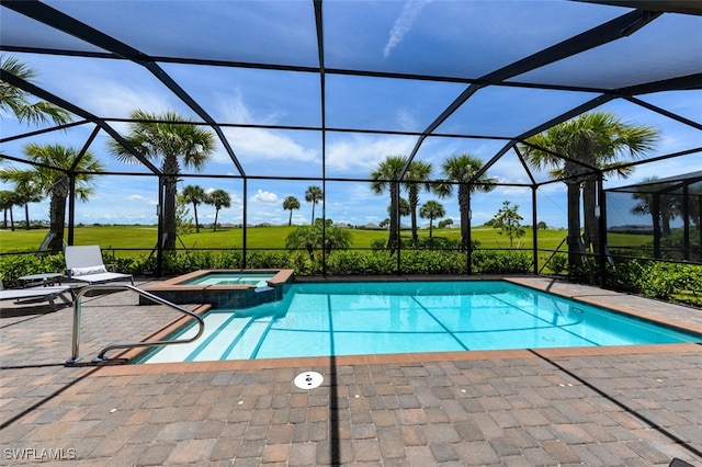 view of swimming pool with an in ground hot tub, glass enclosure, and a patio area