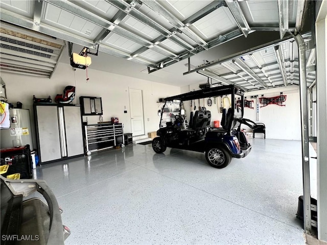 garage with a garage door opener and electric water heater