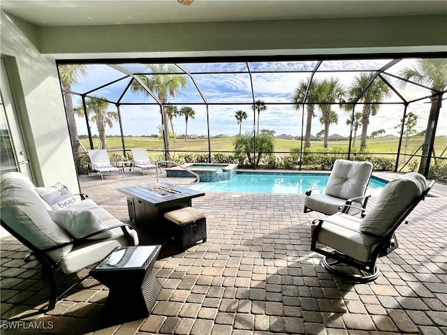 view of patio with a swimming pool with hot tub, a lanai, and an outdoor fire pit