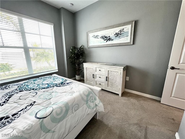 carpeted bedroom featuring multiple windows