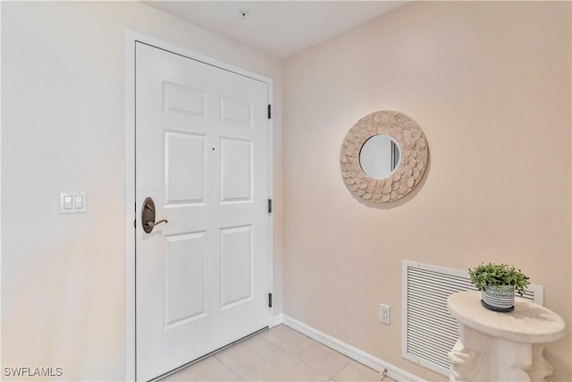 doorway to outside with light tile patterned flooring